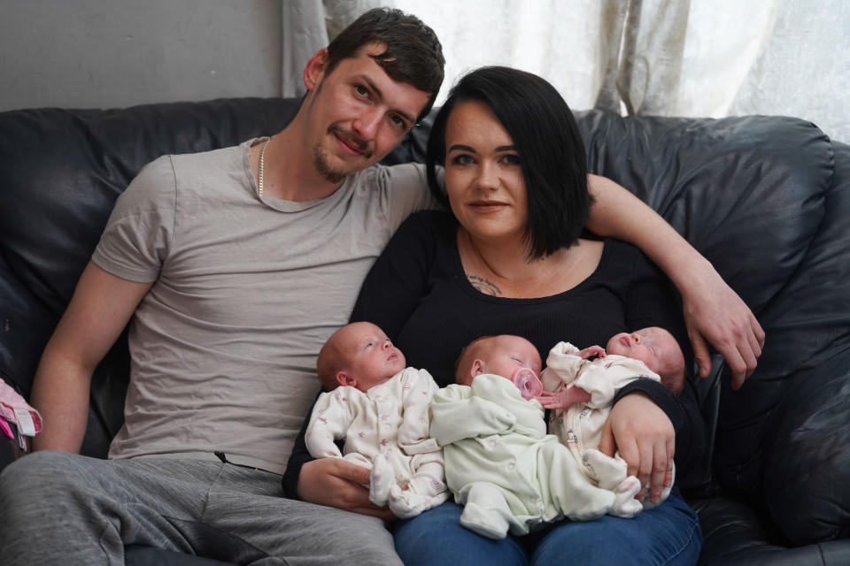 Dad James Casper, 26 and mum Jenni Casper 27, with their newly born triplets, Evalynn Casper, Harper-Gwen Casper and Marvella Casper. (Tom Maddick/SWNS)