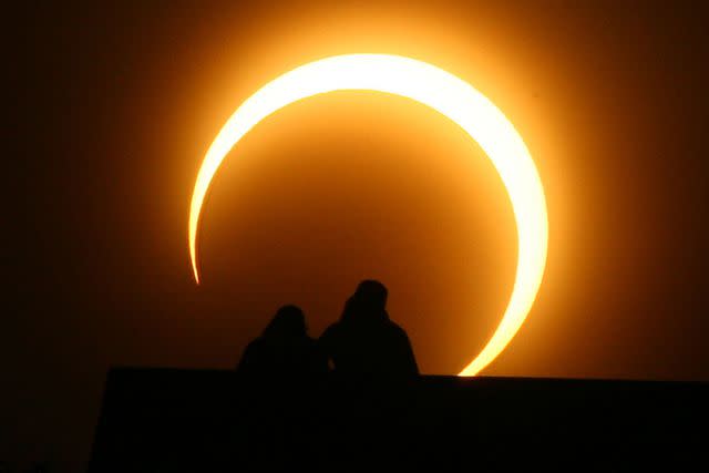 <p>STR/AFP via Getty</p> A solar eclipse in China on Jan. 15, 2010
