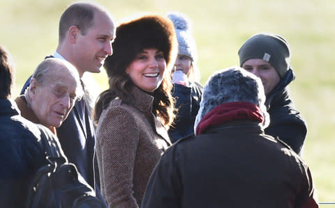 The Duchess beams at a member of the public, while Prince Philip appears to speak - Credit: PA