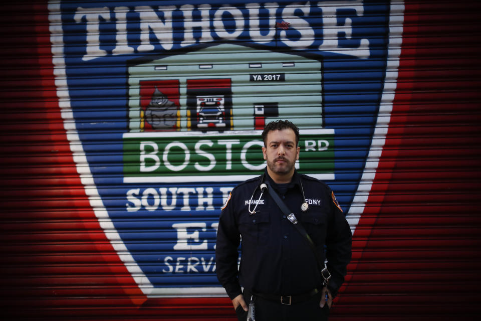 In this April 23, 2020, photo FDNY paramedic Alex Tull, who has recently recovered from COVID-19 poses for a photo in the Bronx borough of New York. (AP Photo/John Minchillo)