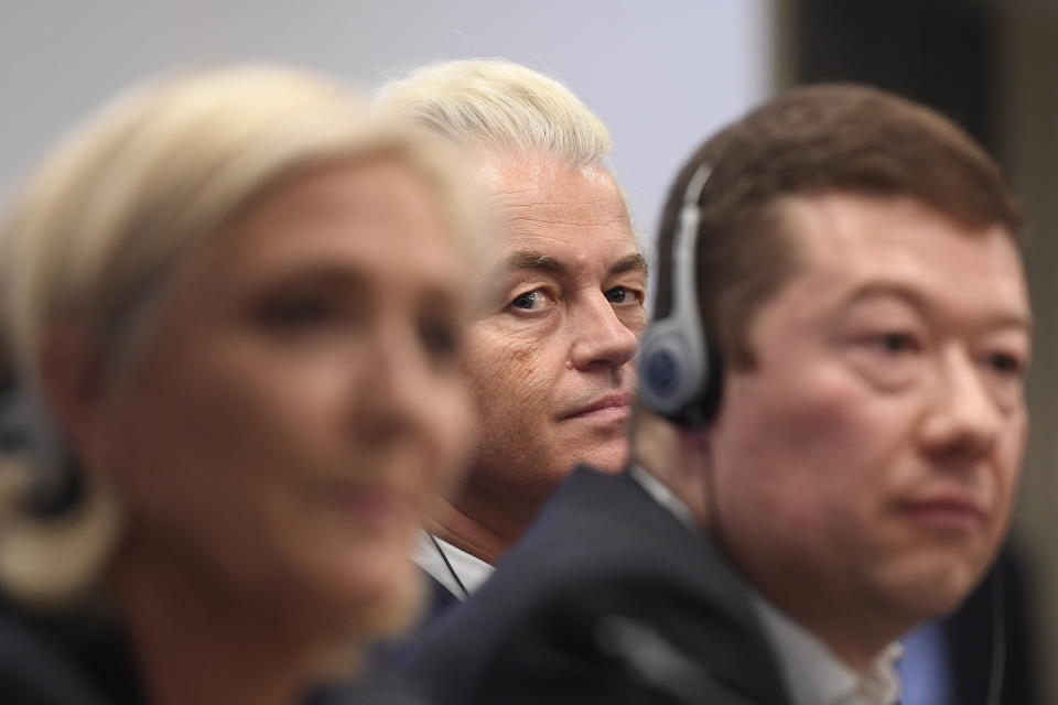 Leader of Dutch Party for Freedom Geert Wilders, center, peers at the photographer, as leader of French National Front Marine Le Pen, left, and Czech far-right Freedom and Direct Democracy (SPD) head Tomio Okamura, right, sit by as they attend a press conference before the rally against "dictate of European Union" staged by SPD in Prague, Czech Republic, Thursday, April 25, 2019. (Ondrej Deml/CTK via AP)