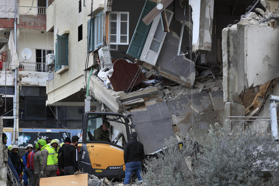Civil defence and rescue workers remove rubbles from a building that was attacked Wednesday night by an Israeli airstrike, in Nabatiyeh town, south Lebanon, Thursday, Feb. 15, 2024. The airstrike killed and injured several people and child, Lebanon's state news agency reported.(AP Photo/Mohammed Zaatari)