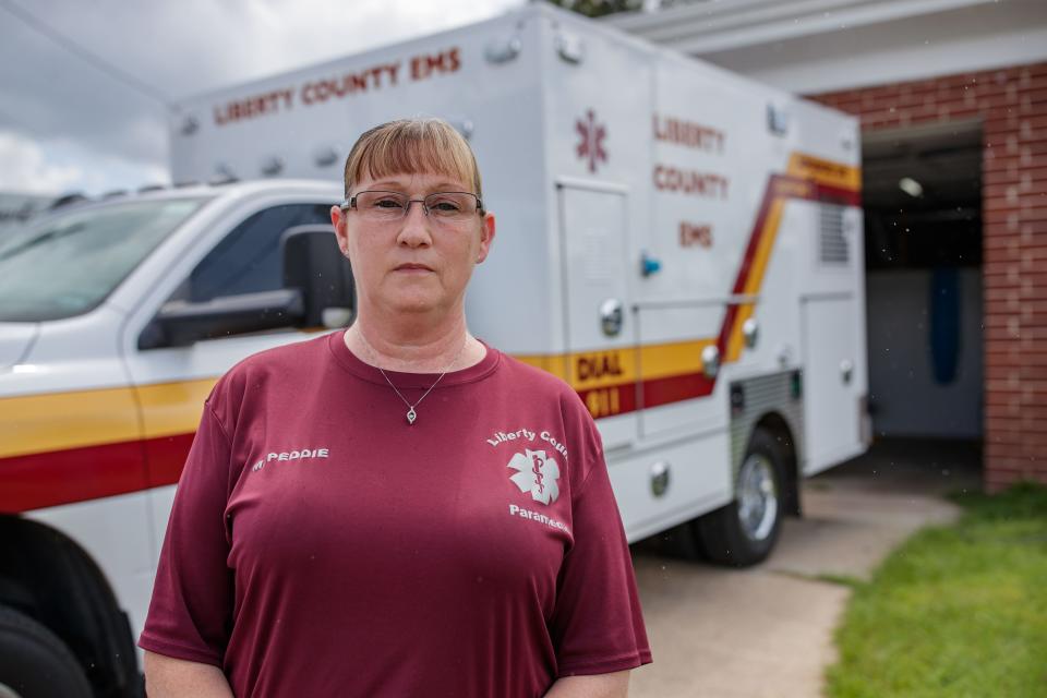 Melissa Peddie, Liberty County, director of emergency medical services in Liberty County, Florida, stands in front of the county's only active ambulance to transport patients Wednesday, July 21, 2021.