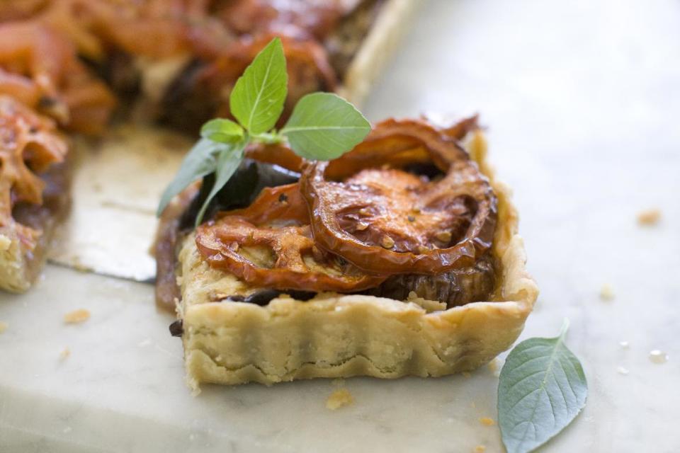 Caramelized Onion, Eggplant and heirloom tomato tart.This Aug. 5, 2013 photo shows caramelized onion, eggplant and heirloom tomato tart in Concord, N.H. (AP Photo/Matthew Mead)