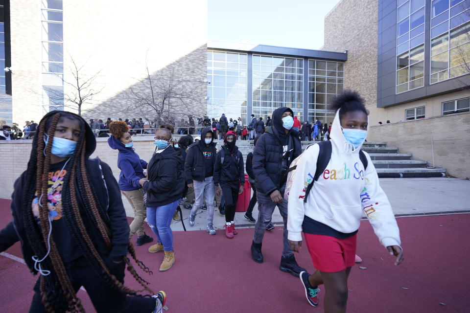 People leave Dunbar High School in Washington on Tuesday, Feb. 8, 2022, after Doug Emhoff, the husband of Vice President Kamala Harris, was whisked out of an event by Secret Service agents following an apparent security concern. (AP Photo/Manuel Balce Ceneta)