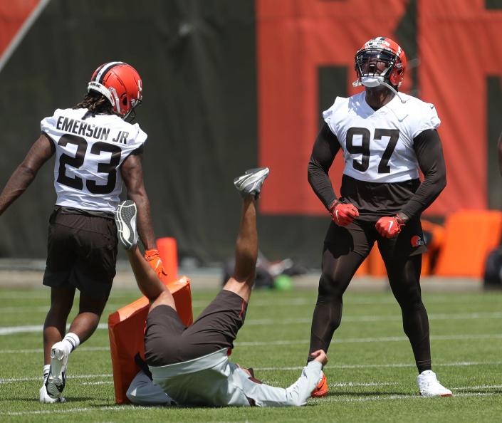 Cleveland Browns defensive tackle Perrion Winfrey, right, celebrates after cornerback Martin Emerson Jr. knocked over a member of the coaching staff in drills during the NFL football team&#39;s rookie minicamp in Berea on Friday.