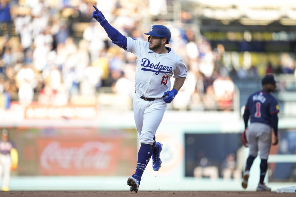 Los Angeles Dodgers' Max Muncy (13) celebrates as he runs the bases after hitting a home run during the second inning of a baseball game against the Atlanta Braves in Los Angeles, Saturday, May 4, 2024. (AP Photo/Ashley Landis)