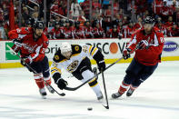 WASHINGTON, DC - APRIL 22: Matt Hendricks #26 and Jay Beagle #83 of the Washington Capitals battle for the puck with Rich Peverley #49 of the Boston Bruins in Game Six of the Eastern Conference Quarterfinals during the 2012 NHL Stanley Cup Playoffs at Verizon Center on April 22, 2012 in Washington, DC. Hendricks was called for a two minute penalty for tripping Peverley. (Photo by Patrick McDermott/Getty Images)