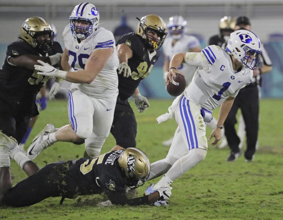 UCF linebacker Tatum Bethune (15) sacks BYU quarterback Zach Wilson (1) in the fourth quarter in the Boca Raton Bowl NCAA college football game at FAU Stadium in Boca Raton, Fla. Tuesday, Dec. 22, 2020.(Al Diaz/Miami Herald via AP)