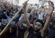 Supporters of Tehreek-e-Labiak Pakistan, a banned Islamist party, chant slogans during a protest on the arrest of their party leader Saad Rizvi, who was demanding the government to expel French ambassador, in Lahore, Pakistan, Monday, April 19, 2021. The outlawed Pakistani Islamist political group freed 11 policemen almost a day after taking them hostage in the eastern city of Lahore amid violent clashes with security forces, the country's interior minister said Monday. (AP Photo/K.M. Chaudary)