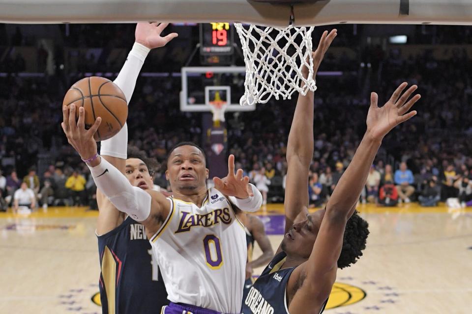 Lakers guard Russell Westbrook puts up a shot in front of New Orleans&#39; Jaxson Hayes and Herbert Jones.