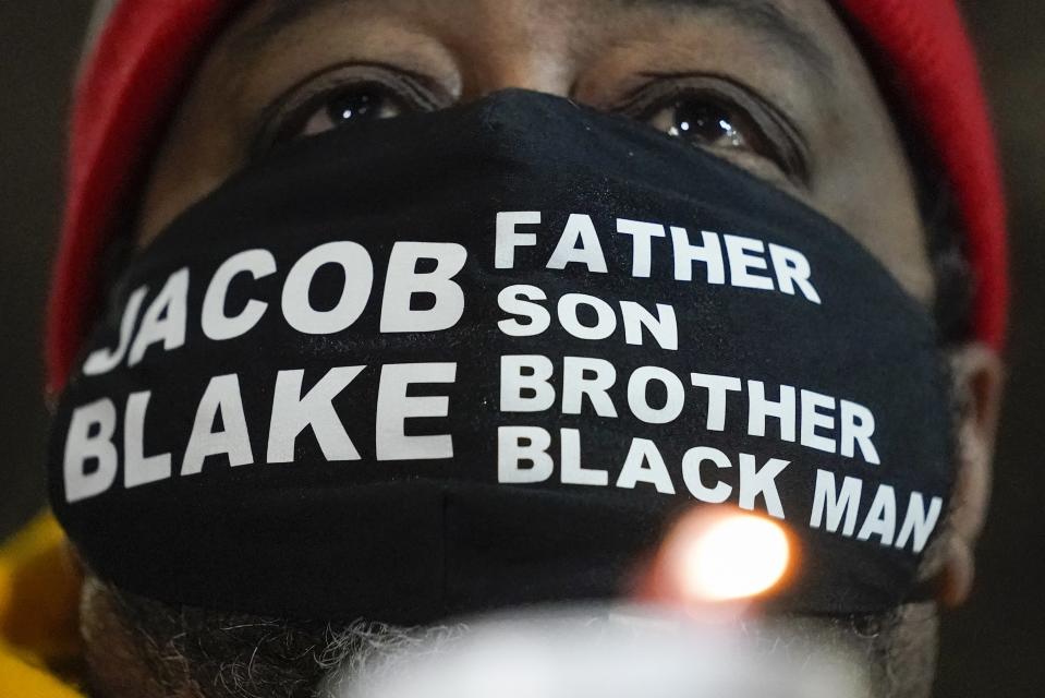 Jacob Blake Sr., father of Jacob Blake, holds a candle at a rally Monday, Jan. 4, 2021, in Kenosha, Wis. (AP Photo/Morry Gash)