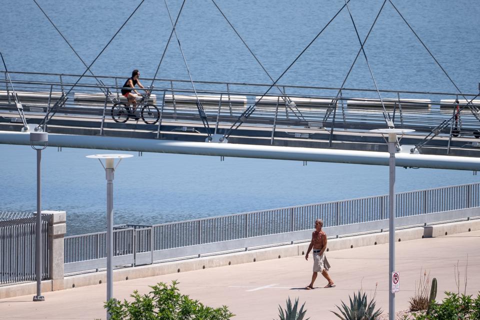 People exercise at Tempe Town Lake on April 28, 2023.