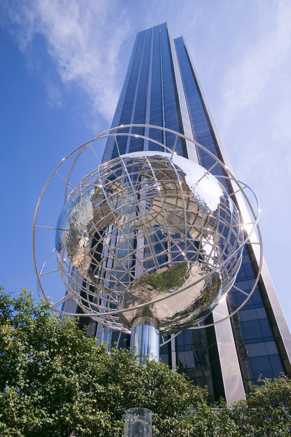 A silver globe fixture rests in front of the Trump International Hotel & Tower skyline