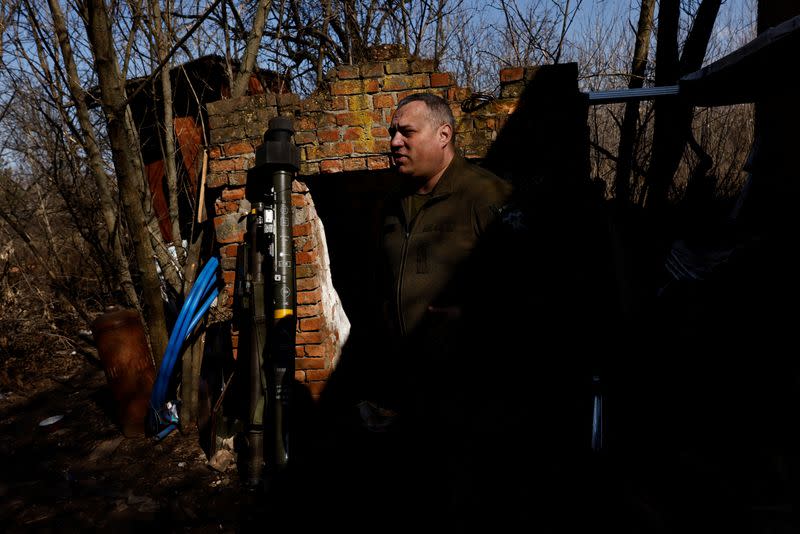 Anti-aircraft unit serviceman of the 10th Mountain Assault Brigade, call sign "Kamin", 42, is seen next to portable anti-aircraft missile systems