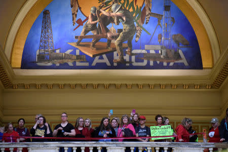 FILE PHOTO: Teachers rally inside the state Capitol on the second day of a teacher walkout to demand higher pay and more funding for education in Oklahoma City, Oklahoma, U.S., April 3, 2018. REUTERS/Nick Oxford/File Photo
