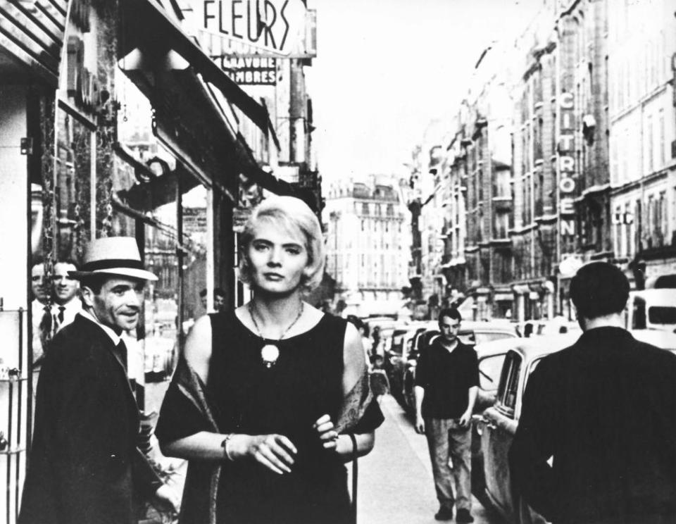 Actor Corinne Marchand walks down a street in Paris in the film Cléo from 5 to 7, made in 1961