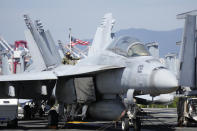 U.S. soldier checks the F/A-18 Super Hornet fighter jet on the deck of the aircraft carrier USS Ronald Reagan in Busan, South Korea, Friday, Sept. 23, 2022. The nuclear-powered aircraft carrier arrived in Busan port on Friday ahead of the two countries' joint military exercise that aims to show their strength against growing North Korean threats. (AP Photo/Lee Jin-man)