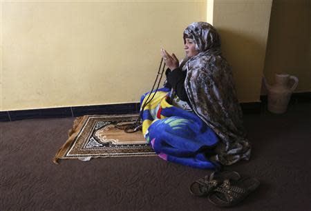 An Afghan female prisoner prays in Herat's prison for women, western Afghanistan, December 8, 2013. REUTERS/Omar Sobhani