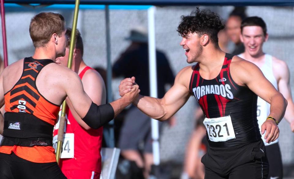 Central Kitsap’s Roderick Schenk (left) is congratulated by Yelm’s Bradyen Platt after throwing a new meet record 219’ 1” in the 3A boys javelin competition during the opening day of the WIAA state track and field championships at Mount Tahoma High School in Tacoma, Washington, on Thursday, May 25, 2023.