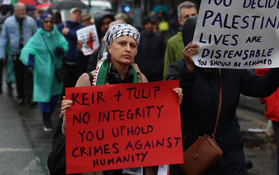 A pro-Palestinian protester accuses the Labour leader of upholding 'crimes against humanity'