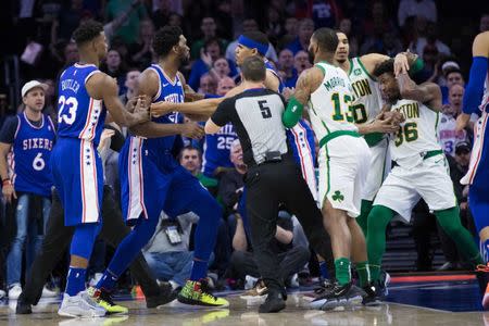 Mar 20, 2019; Philadelphia, PA, USA; Philadelphia 76ers center Joel Embiid (21) and Boston Celtics guard Marcus Smart (36) are separated by teammates after an altercation during the third quarter at Wells Fargo Center. Mandatory Credit: Bill Streicher-USA TODAY Sports