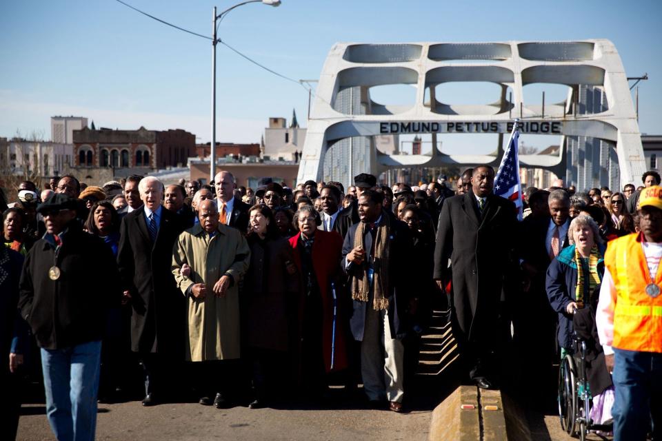 Arm in arm with Congresswoman Terri Sewell and Civil rights legend and Congressman John Lewis, Vice President Joe Biden marches across the Edmund Pettus Bridge during the 48th annual Bridge Crossing Ceremony in Selma, Alabama. March 3,&nbsp;2013.