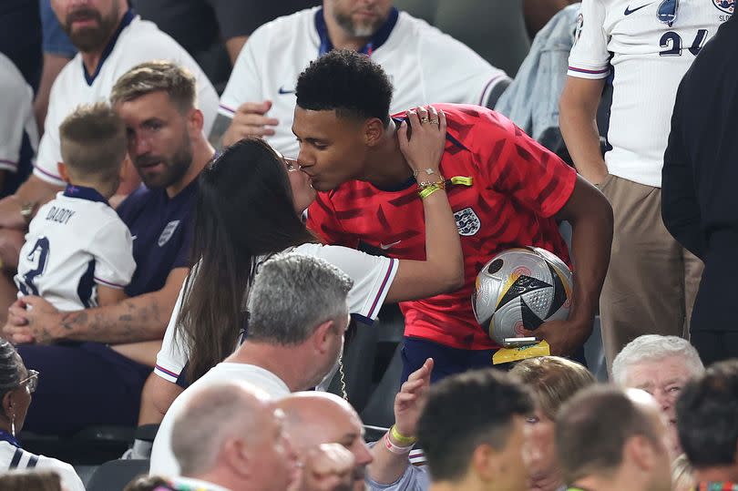 Ellie Alderson and Ollie Watkins of England share a kiss as they celebrate after England's win