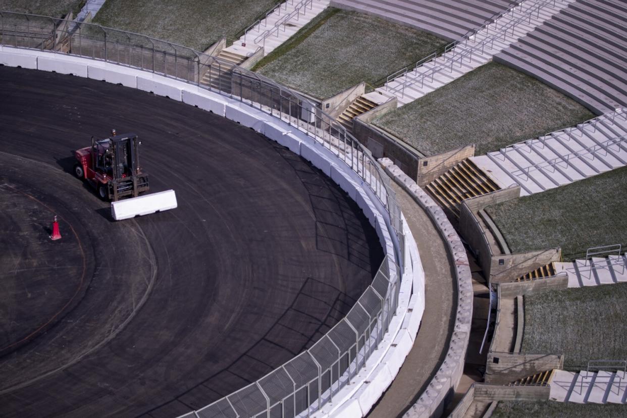 Construction crews transform the Coliseum from a football stadium to a quarter-mile short track NASCAR exhibition race track.