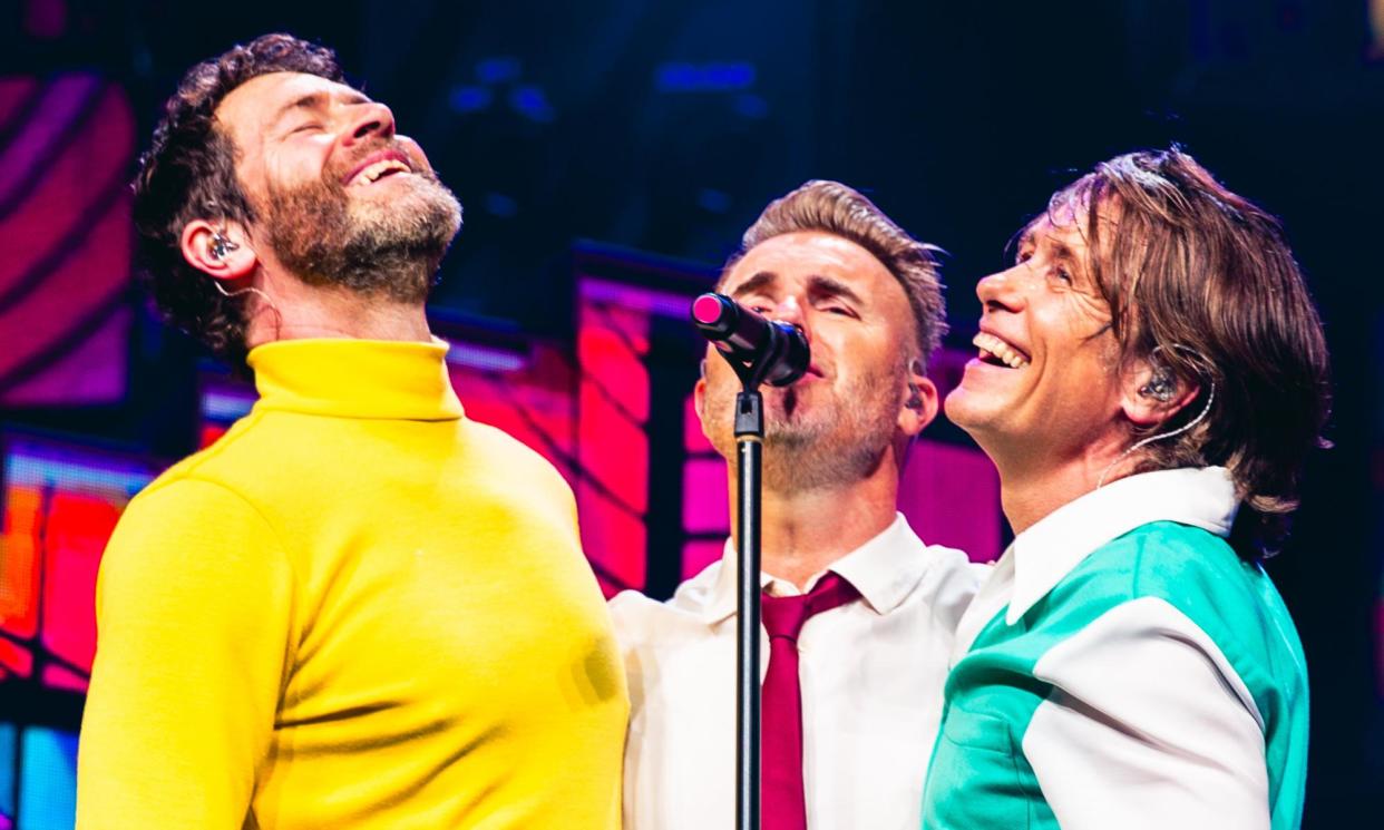 <span>Howard Donald, Gary Barlow and Mark Owen of Take That performing at the O2 Arena.</span><span>Photograph: RHM Productions</span>