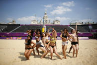 Dancers rehearse their performances for the London 2012 Olympic beach volleyball matches at the main court at the Horse Guards Parade in London July 25, 2012. (REUTERS/Marcelo del Pozo)