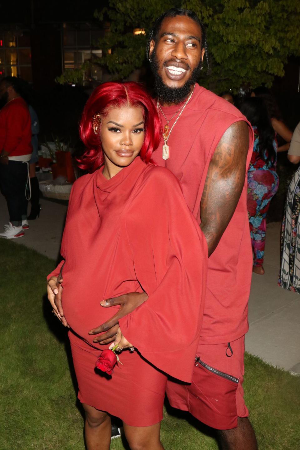 <p>Color coordinated in all-red ensembles, Teyana Taylor and husband Iman Shumpert cradle Taylor’s baby bump during her baby shower on Saturday at The Gathering Spot in Atlanta.</p>