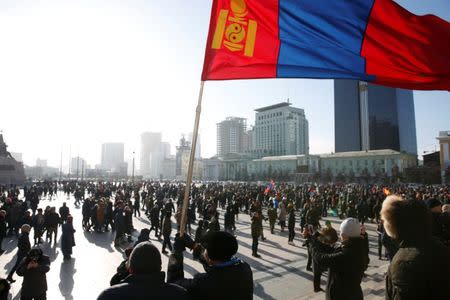 A protester waves a Mongolian flag during a demonstration to demand the resignation of Mongolia's parliamentary speaker Enkhbold Miyegombo, at Sukhbaatar Square in Ulaanbaatar, Mongolia December 27, 2018. REUTERS/B. Rentsendorj