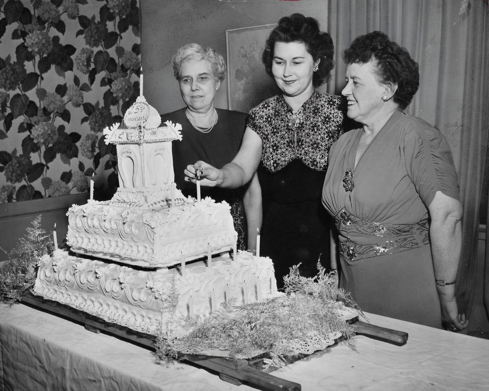 Akron City Woman's Club members Helen Wolle, Edria Wolfe and Lavinia Protheroe admire the group's 25th anniversary cake in February 1948.