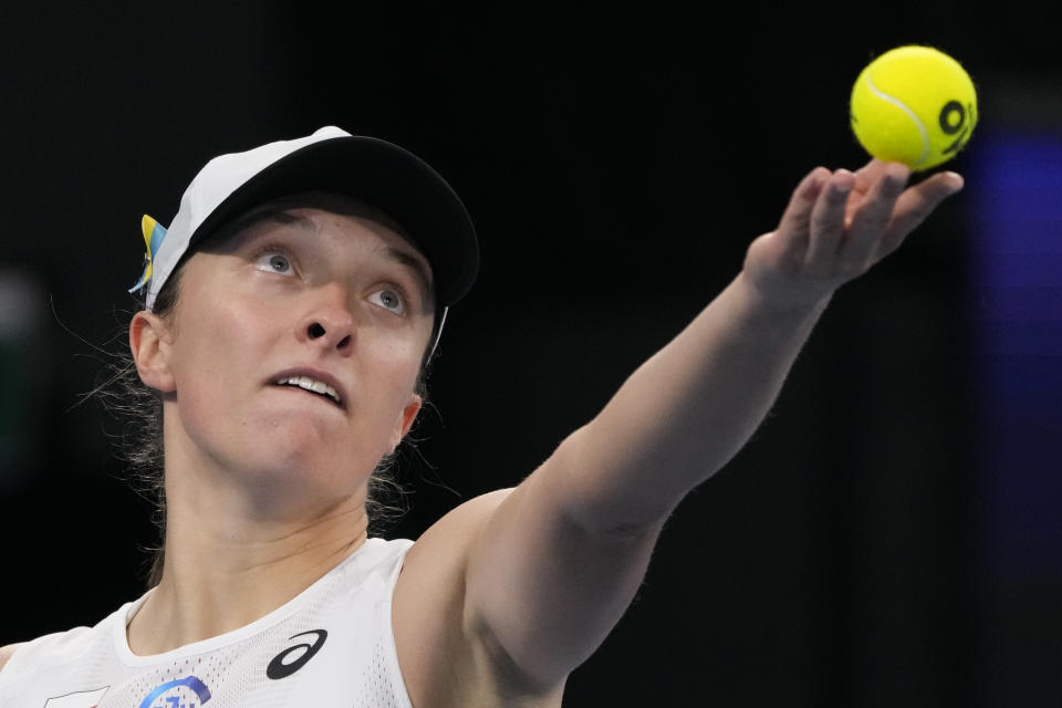 Poland's Iga Swiatek serves to United States' Jessica Pegula during their semifinal match at the United Cup tennis event in Sydney, Australia, Friday, Jan. 6, 2023. (AP Photo/Mark Baker)