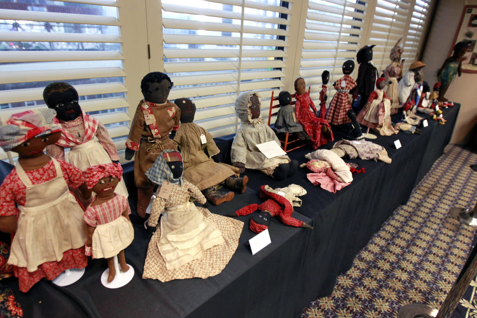 In this Wednesday, July 25, 2012 photo, historic black cloth dolls appear on display in New Orleans. Amid rare antique dolls crafted in porcelain, whimsical Kewpies and homage to contemporary icon Barbie, cloth dolls in the image of African-Americans drew special attention as more than 1,200 collectors gathered in New Orleans for the annual convention of the United Federation of Doll Clubs. (AP Photo/Gerald Herbert)