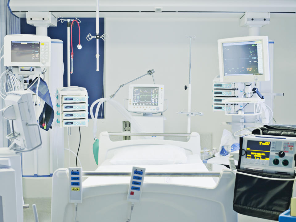 A hospital room with bed and medical devices.