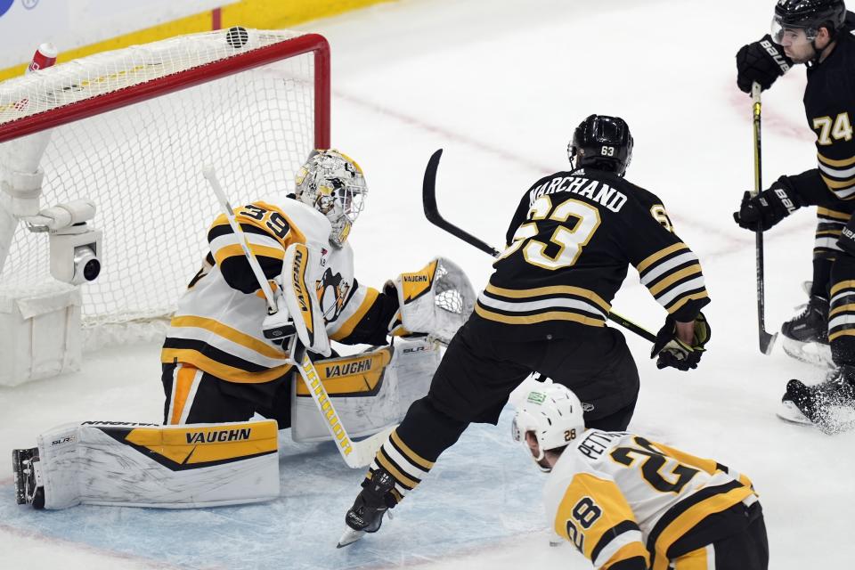 Boston Bruins' Brad Marchand (63) scores on Pittsburgh Penguins' Alex Nedeljkovic (39) during the second period of an NHL hockey game, Saturday, March 9, 2024, in Boston. (AP Photo/Michael Dwyer)