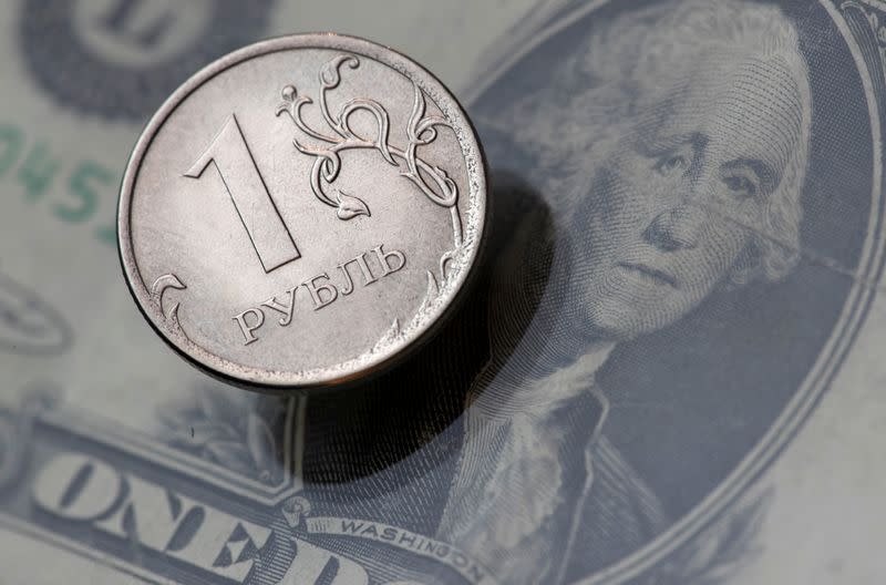 FILE PHOTO: A view shows a Russian rouble coin and a U.S. dollar banknote in this picture illustration