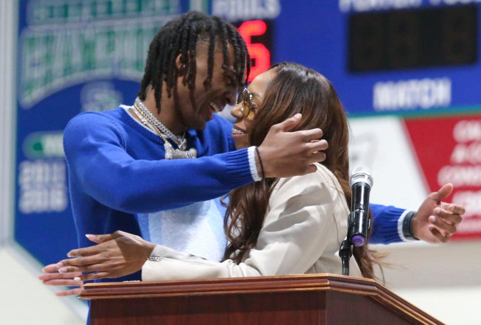 Nah'shon "Bones" Hyland hugs his mother, Marshay Hyland, as the St. Georges graduate is honored in a ceremony to retire his number five St. Georges Technical High School basketball jersey, Friday, Jan. 27, 2023.