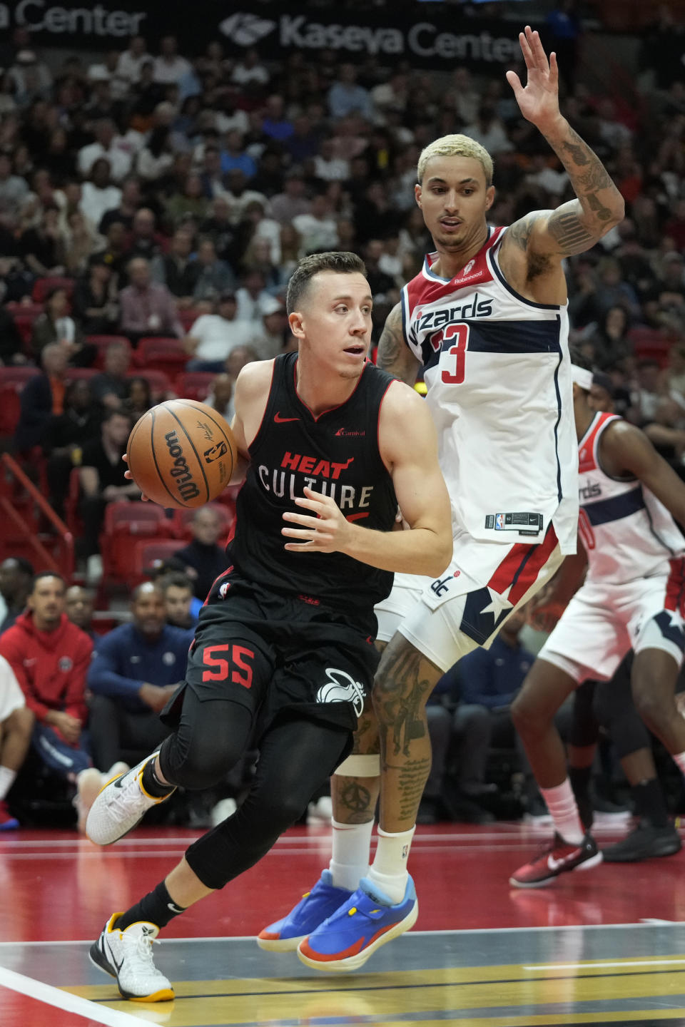 Miami Heat forward Duncan Robinson (55) drives past Washington Wizards forward Kyle Kuzma (33) during the first half of an NBA basketball game, Friday, Nov. 3, 2023, in Miami. (AP Photo/Wilfredo Lee)