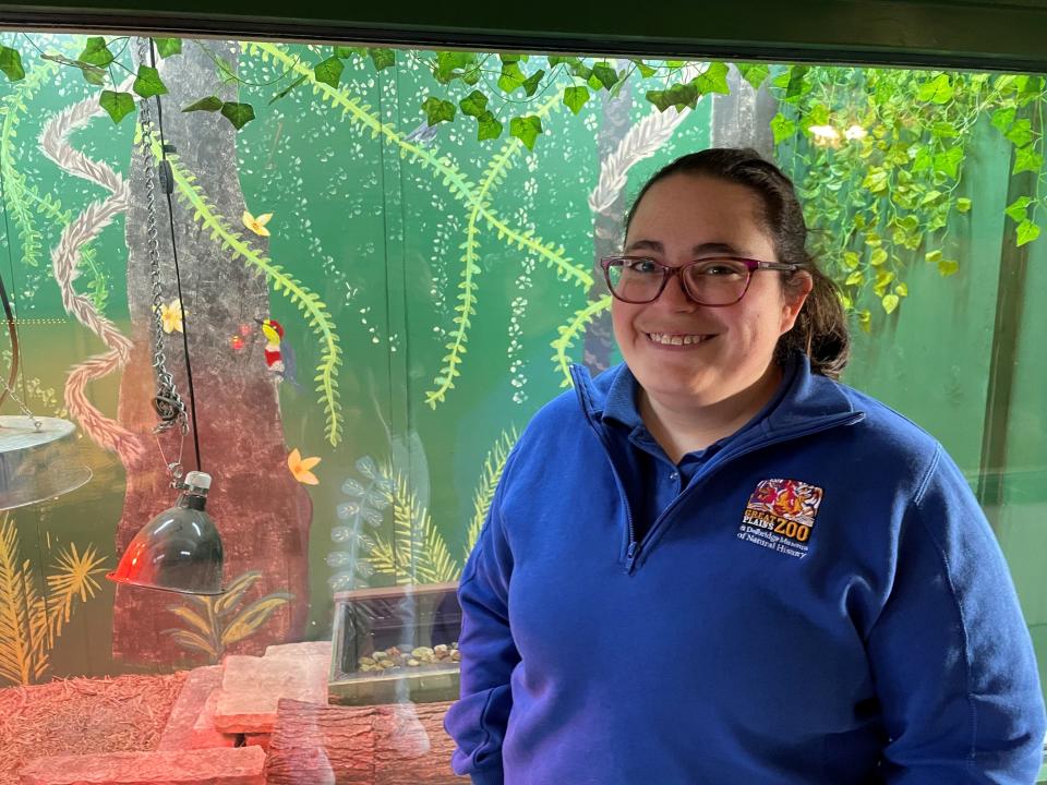 Katy Carchedi stands in front of a mural she painted at the Americas exhibit at the Great Plains Zoo in Sioux Falls on Wednesday, Dec. 6, 2023. Carchedi designed and painted the 40 animal ornaments on the South Dakota State Capitol Christmas Tree.