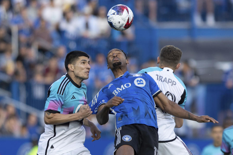 CF Montreal forward Mason Toye, center, wins a header against Minnesota United defender Miguel Tapias, left, and midfielder Will Trapp, right, during first-half MLS soccer match action in Montreal, Saturday, June 10, 2023. (Evan Buhler/The Canadian Press via AP)