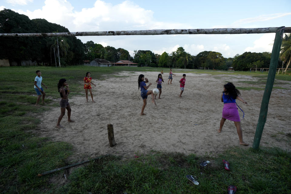 Indigenous Tembe children play soccer in the center of the Tenetehar Wa Tembe village in the Alto Rio Guama Indigenous territory, in Paragominas municipality, in Para state, Brazil, Monday, May 29, 2023. (AP Photo/Eraldo Peres)