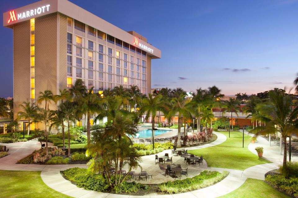 Marriott hotel overseeing a tropical garden with swimming pool.