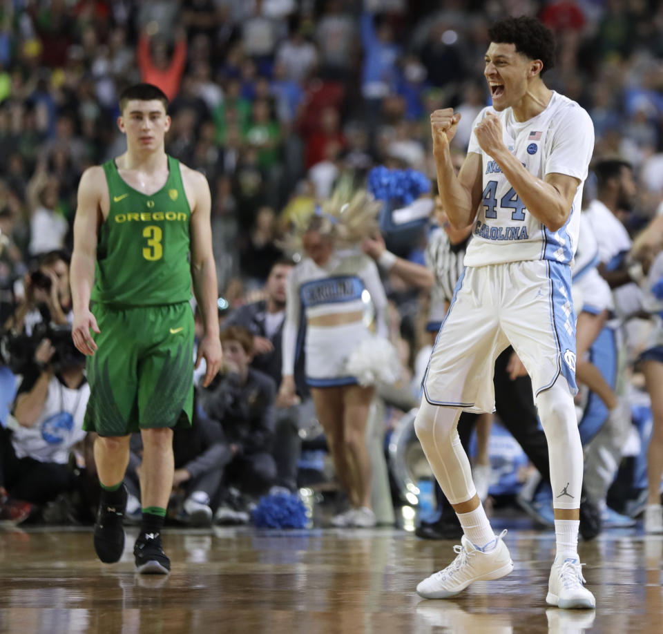 North Carolina forward Justin Jackson (44) celebrates in front of Oregon guard Payton Pritchard (3) at the end of a semifinal in the Final Four NCAA college basketball tournament, Saturday, April 1, 2017, in Glendale, Ariz. North Carolina won 77-76. (AP Photo/Mark Humphrey)