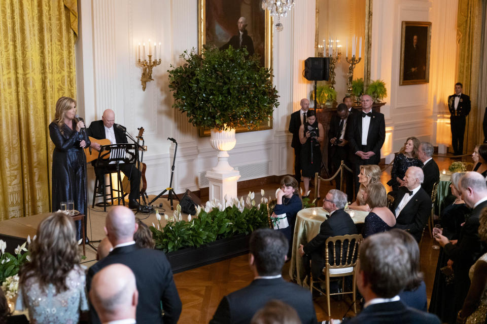 President Joe Biden and first lady Jill Biden listen to country singer Trisha Yearwood perform during a reception for members of the National Governors Association and their spouses in the East Room of the White House in Washington, Saturday, Feb. 24, 2024. (AP Photo/Stephanie Scarbrough)