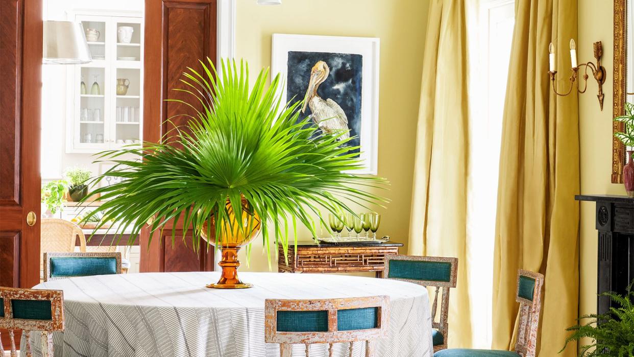 dining room with teal chairs and a big palm centerpiece by brockschmidt and coleman