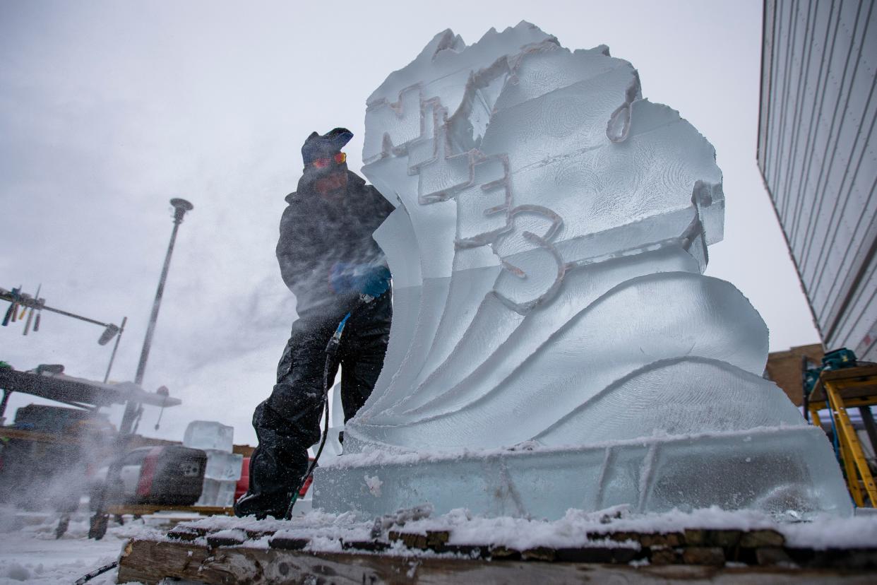 Dean DeMarais, from Dallas, Texas, works on an ice sculpture in advance of the Hunter Ice Festival, Wednesday, Jan. 12, 2022 in Niles, Michigan. 