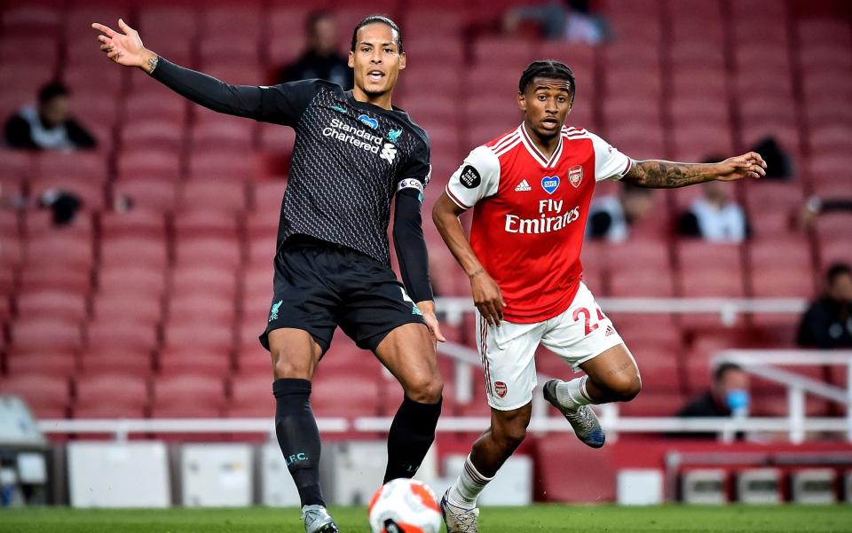 Liverpool's Virgil van Dijk (L) in action against Arsenal's Reiss Nelson (R) during the English Premier League soccer match between Arsenal London and Liverpool FC in London, Britain, 15 July 2020 - SHUTTERSTOCK